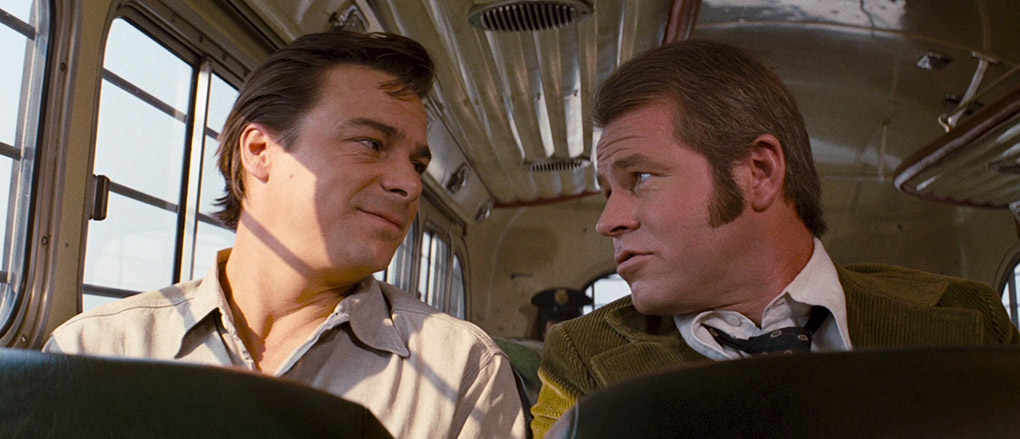 Wilson and Starker converse on the prison bus