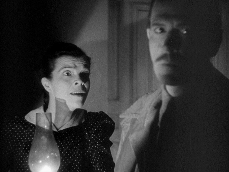 Mrs. Marcy and Dr. Julian Blair are startled in The Devil Commands