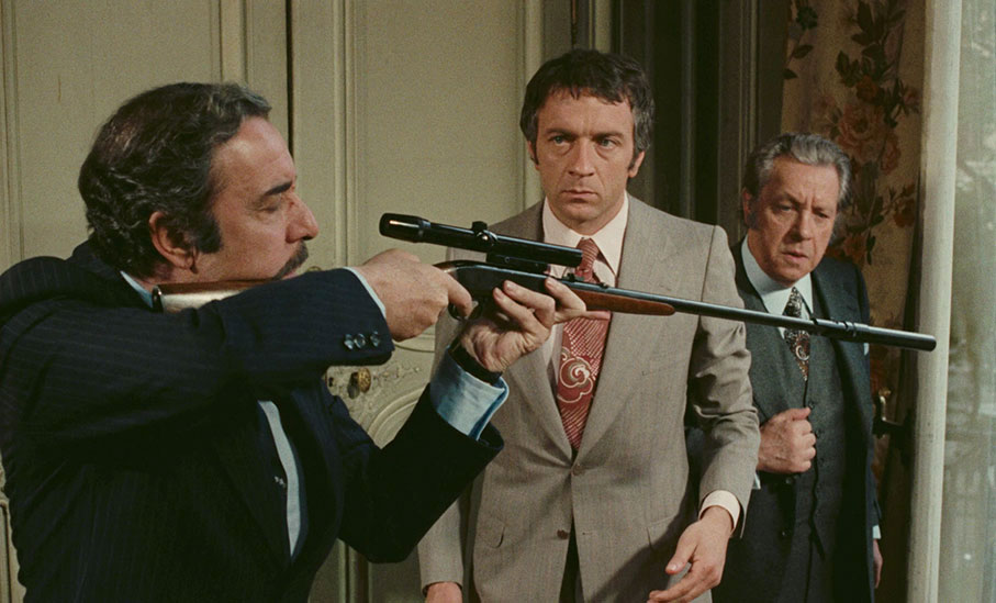 Don Rafael takes aim at a woman on the street as Henri and François look on in alarm