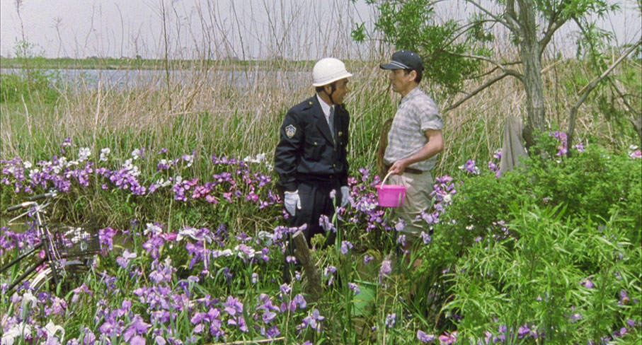 Takuro stands to attention for the klocal policeman