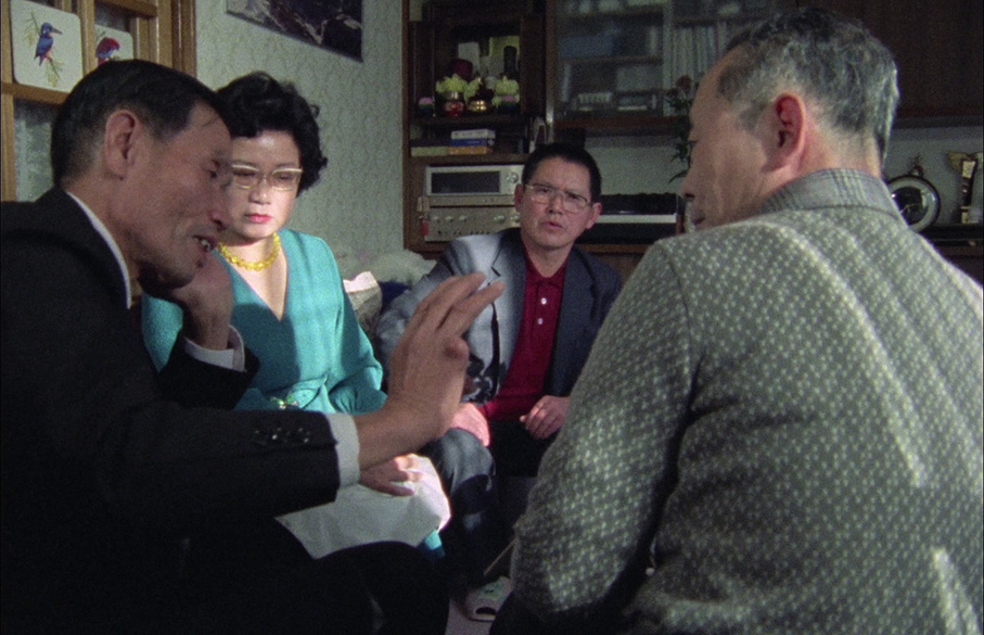 Okuzaki talks to one of the families