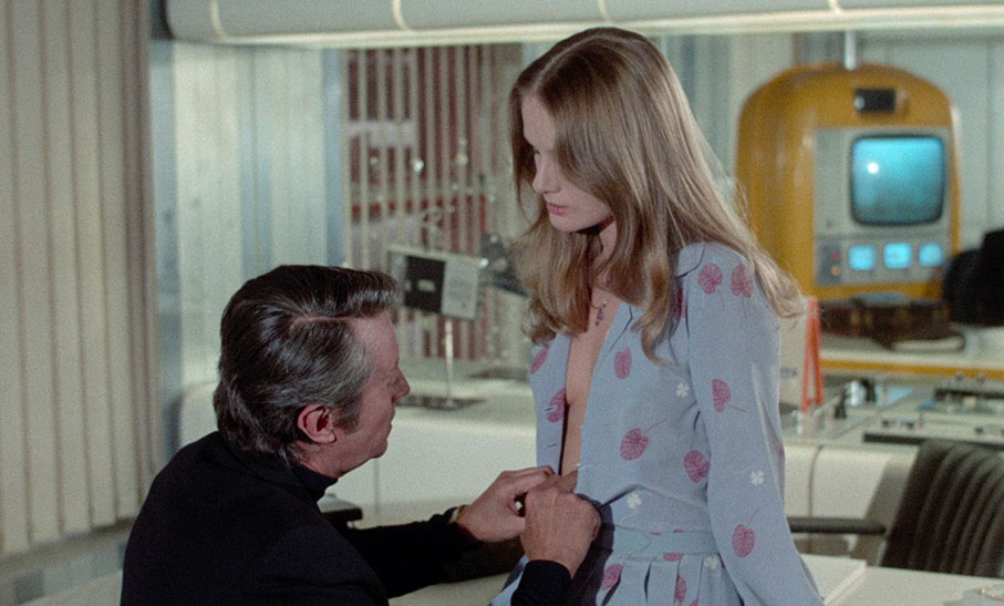 Georges undresses Natalie in his futuristic office