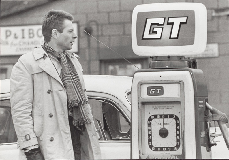 Robert stops at a gas station en route