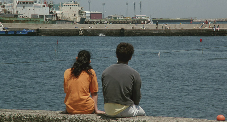 A contemplative moment for Shigeru and Takako, broken by distant slapstick